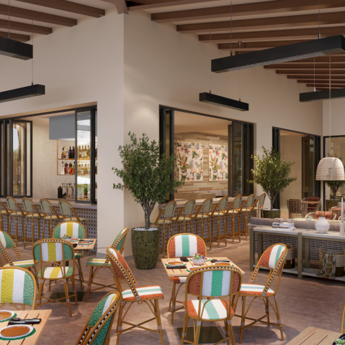 A cozy bookstore caf&eacute; with wooden shelves, warm lighting, plants, and patrons browsing or reading at tables.